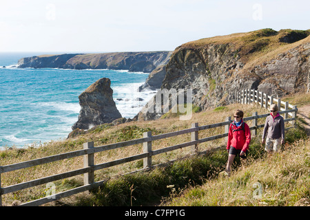 Walkers on the South West Coast Path National Trail at Bedruthan Steps on the west Cornish coast near Bedruthan, Cornwall UK Stock Photo