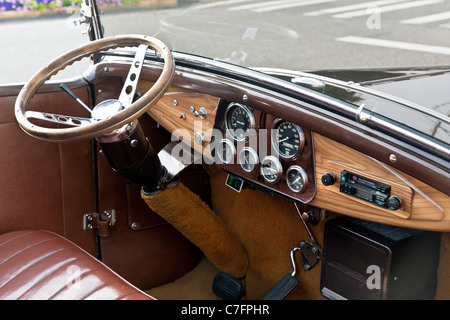 rationally designed dashboard wooden steering wheel & leather interior of classic vintage 1931 Ford Model A car parked on street Stock Photo