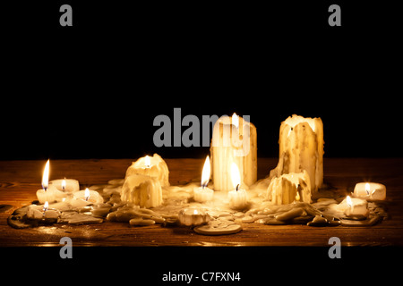Melting candle in wooden shelf Stock Photo