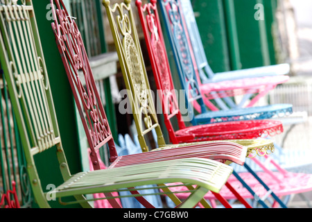 vintage iron chairs on display in a shop front Stock Photo