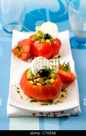 Stuffed tomatoes with goat cheese. Recipe available. Stock Photo