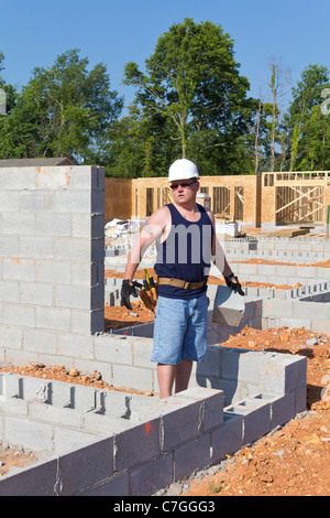 Carpenter Working On New Apartment Community Construction Stock Photo