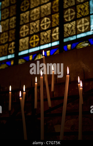 Lit candles in a church Stock Photo