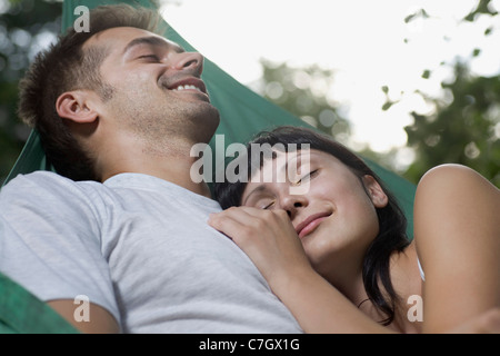 A young couple lying together in a hammock Stock Photo