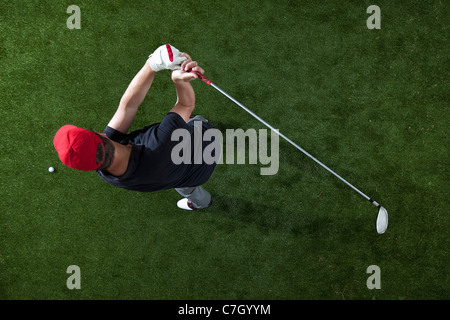 A golfer swinging a golf club, overhead view Stock Photo