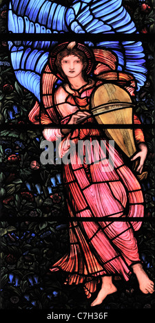 A stained glass window, by Edward Burne-Jones, depicting a winged angel playing a Vielle Stock Photo