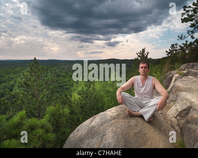 Young man meditating in the nature. Algonquin, Ontario, Canada. Stock Photo