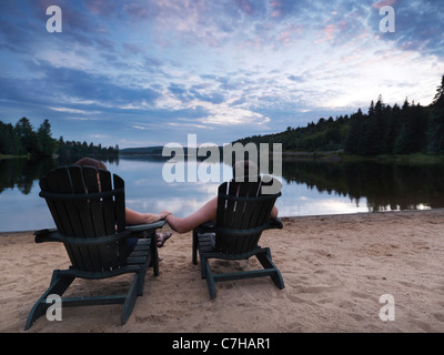 Couple enjoying sunset at the Lake of Two Rivers in Algonquin Provincial Park, Ontario, Canada. Stock Photo