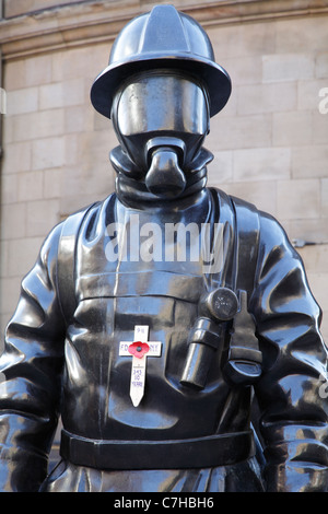 Citizen Firefighter sculpture with a poppy tribute for the 10th Anniversary of 911, Glasgow city centre, Scotland, UK Stock Photo