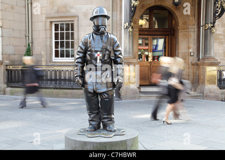 Citizen Firefighter sculpture with a poppy tribute for the 10th Anniversary of 911, Glasgow city centre, Scotland, UK Stock Photo