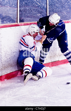 Ice hockey players fighting during a game. Stock Photo