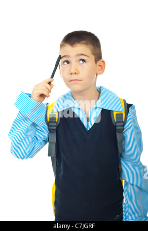 Thinking schoolboy looking up and holding pencil to head isolated on white background Stock Photo