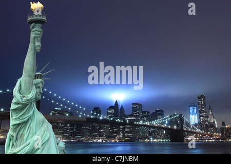 Manhattan Skyline, Brooklyn Bridge and The Statue of Liberty at Night Lights, New York City Stock Photo