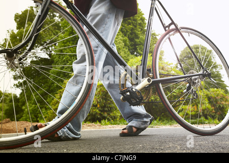 Close up of man walking bicycle Stock Photo