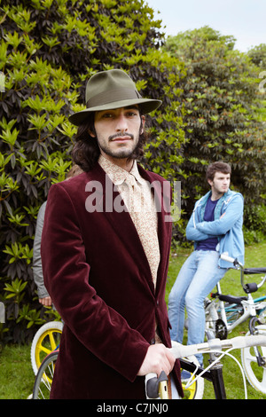 Man with bicycle on in park Stock Photo