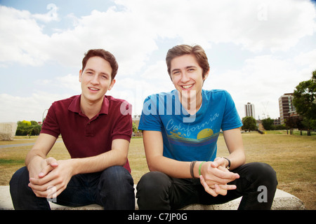 Men sitting on stone bench in park Stock Photo