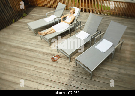Caucasian woman sunbathing in lawn chair Stock Photo - Alamy