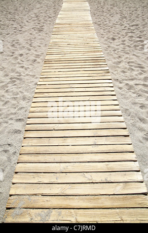 Perspective of wooden path at sandy beach Stock Photo