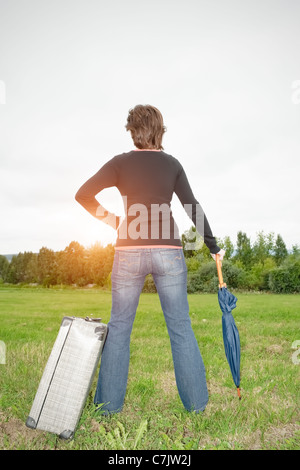 Rear view of a young woman standing on a meadow Stock Photo