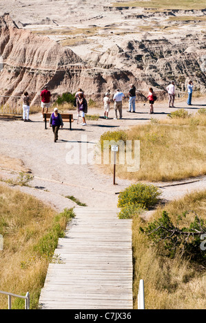 Tourists view the scenery in Badlands National Park from a scenic overlook.a. Stock Photo