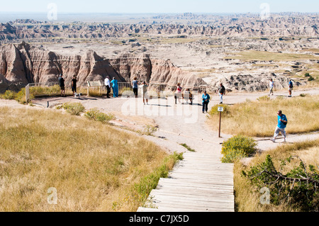 Tourists view the scenery in Badlands National Park from a scenic overlook. Stock Photo