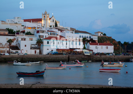 Portugal, Algarve, Ferragudo, Village & Boats at Dusk Stock Photo