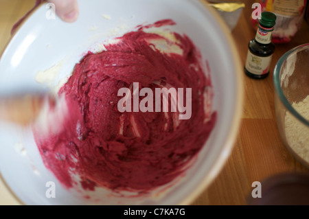 Red velvet cupcake batter/mixture being creamed together Stock Photo