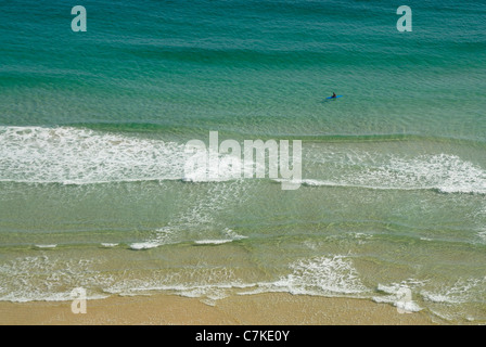 Empty beach scene with one kayaker paddling in beautiful sea. Stock Photo