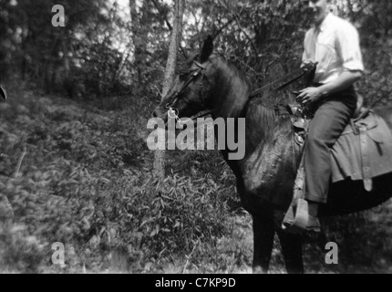 man on horse blurred background mystery male 1930s rural forest Stock Photo