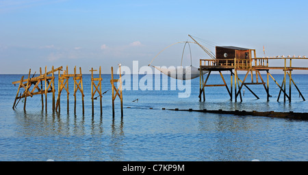 Traditional carrelet fishing hut with lift net on the beach at sea, Loire-Atlantique, Pays de la Loire, France Stock Photo