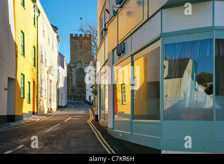 Reflections of a colourful street in Lyme Regis Dorset UK in shop windows