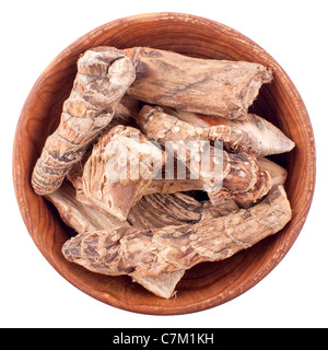 Dry calamus root in a wooden bowl isolated on white background Stock Photo