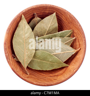 Dry bay leaf in a wooden bowl isolated on white background Stock Photo