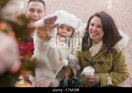 Family looking at Christmas tree in a store