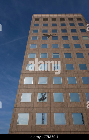 The tall office buildings of Number One London Bridge with a reflected construction crane in a few glass windows. Stock Photo