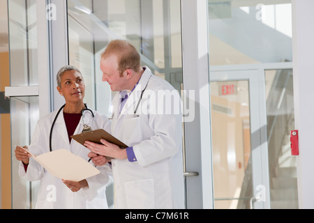 Two doctors discussing a medical report in hospital Stock Photo