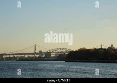 Zoom view, from east River Esplanade north Queensboro Bridge, of Robert Kennedy and Hell Gate bridges, East River. New York City Stock Photo