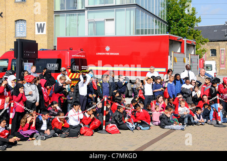 School children awaiting a fire safety talk and demonstration by London Fire Brigade The Excel Centre London England UK Stock Photo