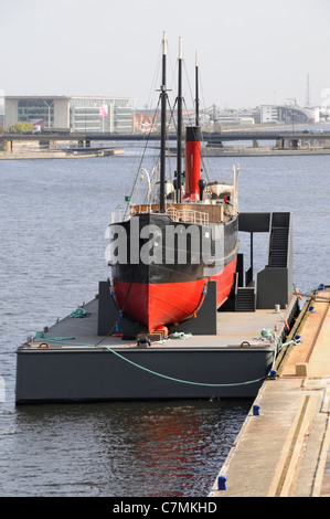 SS Robin steam coaster mounted on floating pontoon undergoing restoration work to become a floating museum seen Royal Docks Newham London England UK Stock Photo