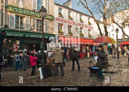 Atmospheric and colorful street scene with cafes and restaurants in the Montmartre artists quarter Stock Photo