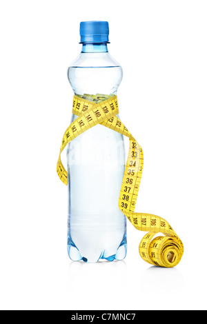 tape measure and mineral water bottle isolated on a blue