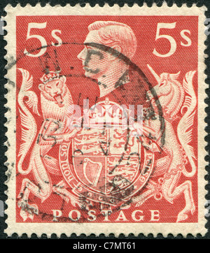 UNITED KINGDOM - 1939: A stamp printed in England, shows the King George VI and Royal Arms Stock Photo