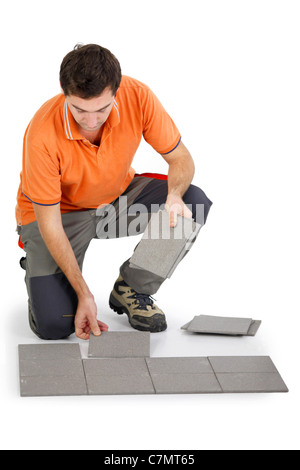 Man laying out tiles on the floor Stock Photo