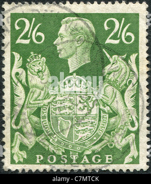 UNITED KINGDOM - 1942: A stamp printed in England, shows the King George VI and Royal Arms Stock Photo