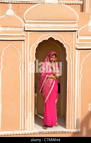 Woman in traditional sari standing in arched door inside Hawa Mahal or Palace of Winds Jaipur Rajasthan India Stock Photo