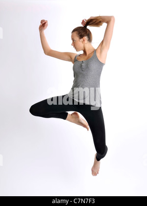 Young woman, 24, jumping Stock Photo