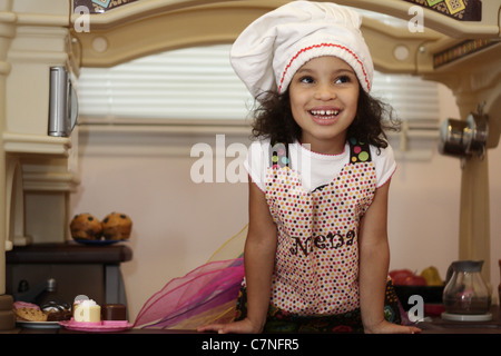 Little girl chef in her kitchen Stock Photo