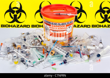 Medical sharps (syringes, needles, blades etc) and a safe disposal box. Stock Photo