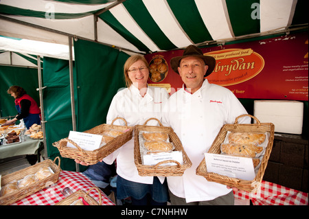 A couple selling fresh baked meat pasties and pies at Aberystwyth Food Fair, September 2011, Wales UK Stock Photo