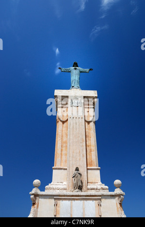 Statue of Jesus arms stretched on a pillar at Monte Toro Stock Photo